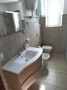 a bathroom with a sink and a toilet at Casa Vacanze da Nonna Chiarina in Anagni