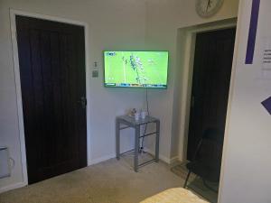 a room with a flat screen tv on the wall at The Gabriels in Shaw