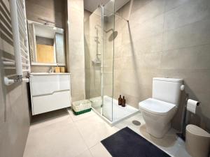 a bathroom with a toilet and a glass shower at Casa Brasão - Celorico de Basto in Celorico de Basto +23 photos