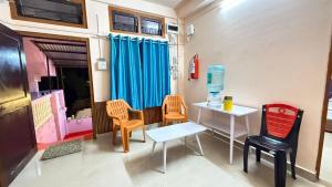 a room with chairs and a table and a table and chairs at Royal Palace in Dibrugarh