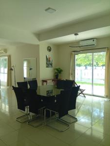 a dining room with a table and chairs at Marina Island Seafront Villa by Monte Villas in Lumut