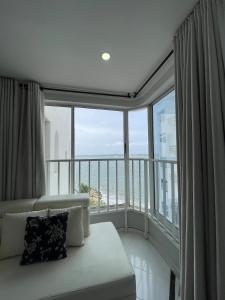a living room with a couch and a large window at Loft in Cartagena with direct beach access in Cartagena de Indias +64 photos