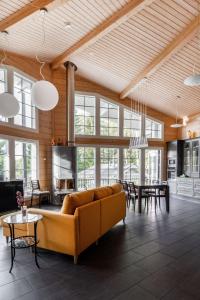 a living room with a couch and a table at Beautiful house and sauna on the lake, 175 m2 in Lappeenranta