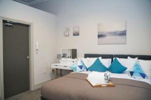 a bedroom with a bed with blue pillows and a sink at Castle View in Dudley