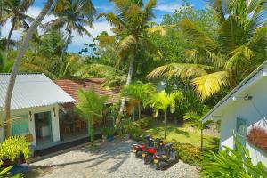 an aerial view of a house with palm trees at Water's Edge Villa in Ahangama