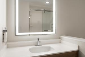 a white bathroom with a sink and a mirror at Holiday Inn Express & Suites Meridian I-20 by IHG in Meridian +34 photos