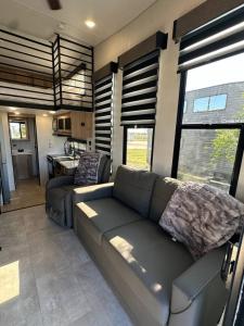 a living room with a couch and a kitchen at Coyote Crossing Tiny Home in Interior