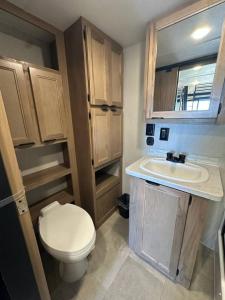 a small bathroom with a toilet and a sink at Coyote Crossing Tiny Home in Interior +15 photos
