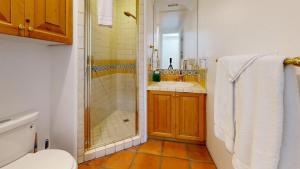 a bathroom with a shower and a toilet and a sink at SV253 2BR 3BA Spa Villa with Pool Access & Views in La Quinta