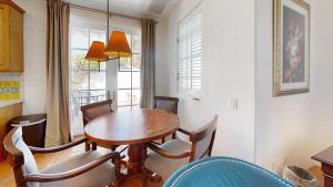a dining room with a wooden table and chairs at SV253 2BR 3BA Spa Villa with Pool Access & Views in La Quinta