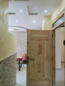a wooden door in a room with a table at vacdellys in Boumerdes