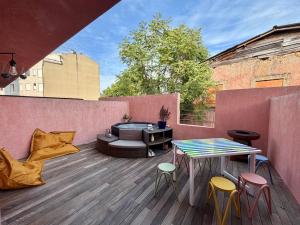 a patio with a table and chairs on a deck at Casa Brasão - Celorico de Basto in Celorico de Basto