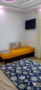 a bed in a room with a blue rug at vacdellys in Boumerdes