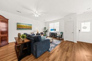 a living room with a blue couch and a table at Southern Oak Cottage in Ladson