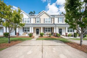 a large white house with trees in front of it at Southern Oak Cottage in Ladson