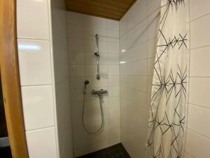 a bathroom with a shower with a shower curtain at Modern Apartment for 3 with Sauna in Kemi +6 photos