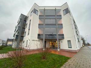a large white building on a city street at Modern Apartment for 3 with Sauna in Kemi