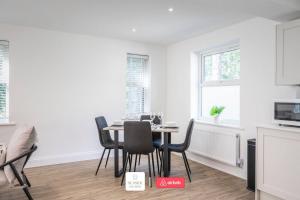a kitchen and dining room with a table and chairs at Beachside Retreat l Sun Terrace l Hot Tub l Free Parking l Seaside Escapes Short Lets & Serviced Accommodation in Bournemouth +15 photos