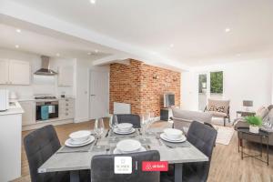 a kitchen and living room with a table and chairs at Beachside Retreat l Sun Terrace l Hot Tub l Free Parking l Seaside Escapes Short Lets & Serviced Accommodation in Bournemouth