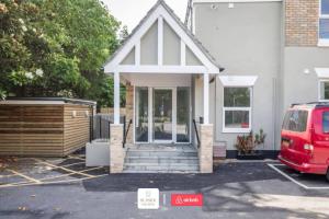 a red van parked in front of a house at Beachside Retreat l Sun Terrace l Hot Tub l Free Parking l Seaside Escapes Short Lets & Serviced Accommodation in Bournemouth