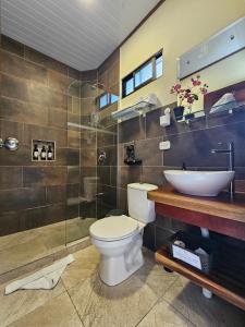 a bathroom with a toilet and a sink and a shower at Calathea Lodge Monteverde in Monteverde Costa Rica +98 photos