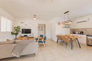 a living room with a couch and a table at Charming hideaway 2 min to Beach in Palm-Eagle Beach