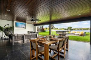 a dining room with a table and chairs and a large window at Dockside Oasis & Private Beach - Hot Tub - Jet Ski in Tampa