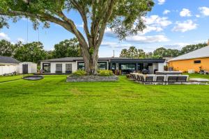 a tree in the yard of a house at Dockside Oasis & Private Beach - Hot Tub - Jet Ski in Tampa