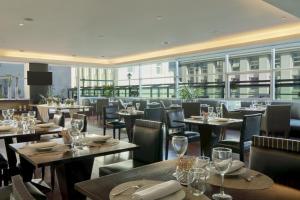 a restaurant with tables and chairs with wine glasses at NH Collection Buenos Aires Centro Histórico in Buenos Aires