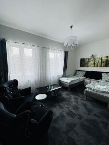 a living room with a bed and a couch at Hotel Leśny Korne koło Kościerzyny - Kaszuby in Korne