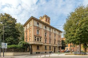 a large building with a tower on top of it at XIIGiugno Boutique in Bologna