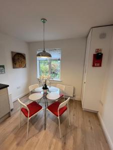 a kitchen and dining room with a table and chairs at Cosy 2 Bed Maisonette near Heathrow & Windsor in Staines