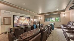 a movie room with leather chairs and a flat screen tv at South Lake Escape Indoor Pool plus Movie Theater in Bijou