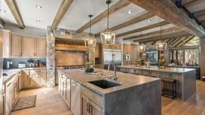 a large kitchen with wooden cabinets and a sink at South Lake Escape Indoor Pool plus Movie Theater in Bijou