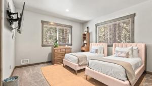 a bedroom with two beds and a dresser and two windows at South Lake Escape Indoor Pool plus Movie Theater in Bijou +39 photos