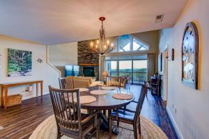 a dining room and living room with a table and chairs at Sugar Sky at The Reserve II in Sugar Mountain