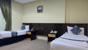 Giường trong phòng chung tại فندق لؤلؤة العنود مكة توصيل مجاني للحرم - Loulouat Al Anood Hotel Makkah Free Shuttle Service +31 ảnh