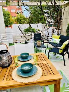 a wooden table with two bowls on it on a patio at Spacious, cozy apartment with garden in Logroño