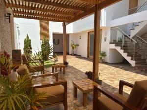 an outdoor patio with tables and chairs and stairs at Betania in Paracas