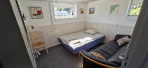 a small room with a bed and a couch at Fihermans House Joanna in Hirtshals