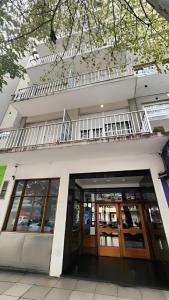 a building with glass doors and a balcony at Muy Buen Departamento con vista al Mar desde el Balcon Dos Dormitorios a dos Cuadras del Mar sobre Avenida Colon in Mar del Plata
