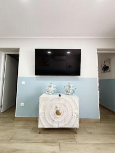 a room with a table with a television on a wall at Sunny Stay Costa Adeje in Adeje