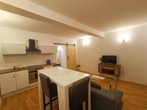 a kitchen with a white table in a room at ZeitWinkelHaus - Apartments with garden in Bad Sooden-Allendorf +7 photos