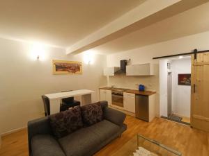 a living room with a couch and a kitchen at ZeitWinkelHaus - Apartments with garden in Bad Sooden-Allendorf