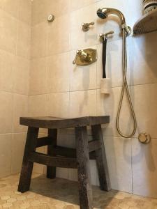 a shower with a bench in a bathroom at Oceanfront - Downtown in historic New England in Salem +42 photos