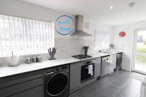 a kitchen with a washer and dryer in it at Contractor Base Newport 3 Bed Van Parking Sleeps 5 in Newport