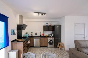 a small kitchen with a couch and a stove top oven at La Casita de Helen in Ronda