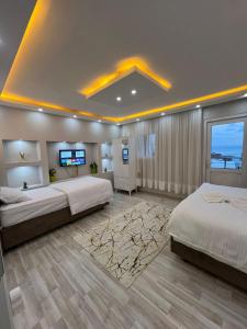 a bedroom with two beds and a flat screen tv at Sultanahmet Blue Suites in Istanbul