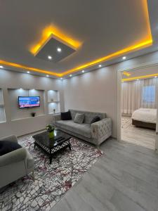 a living room with two couches and a tv at Sultanahmet Blue Suites in Istanbul
