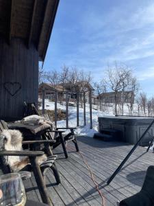 a dog is sitting on a porch of a cabin at Spacious modern family chalet in Solhovda close to hiking, skiing & nature in Hol +20 photos